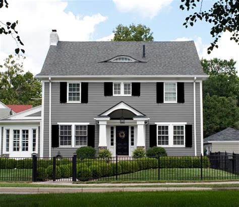 light gray house with metal roof|grey houses with black shutters.